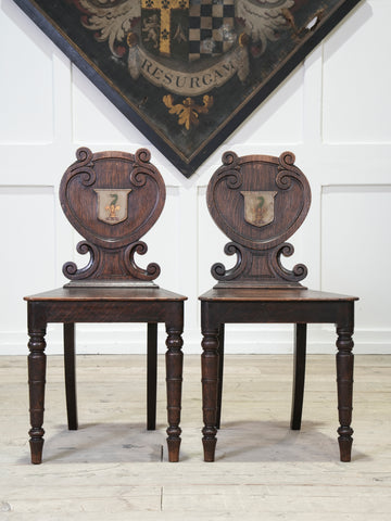 A Pair of 19th Century Oak Armorial Hall Chairs