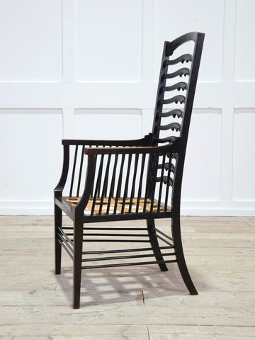 An Ebonised Ladder Back Arm Chair