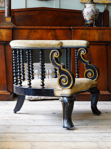 An Ebonised Barrel Back Low Armchair